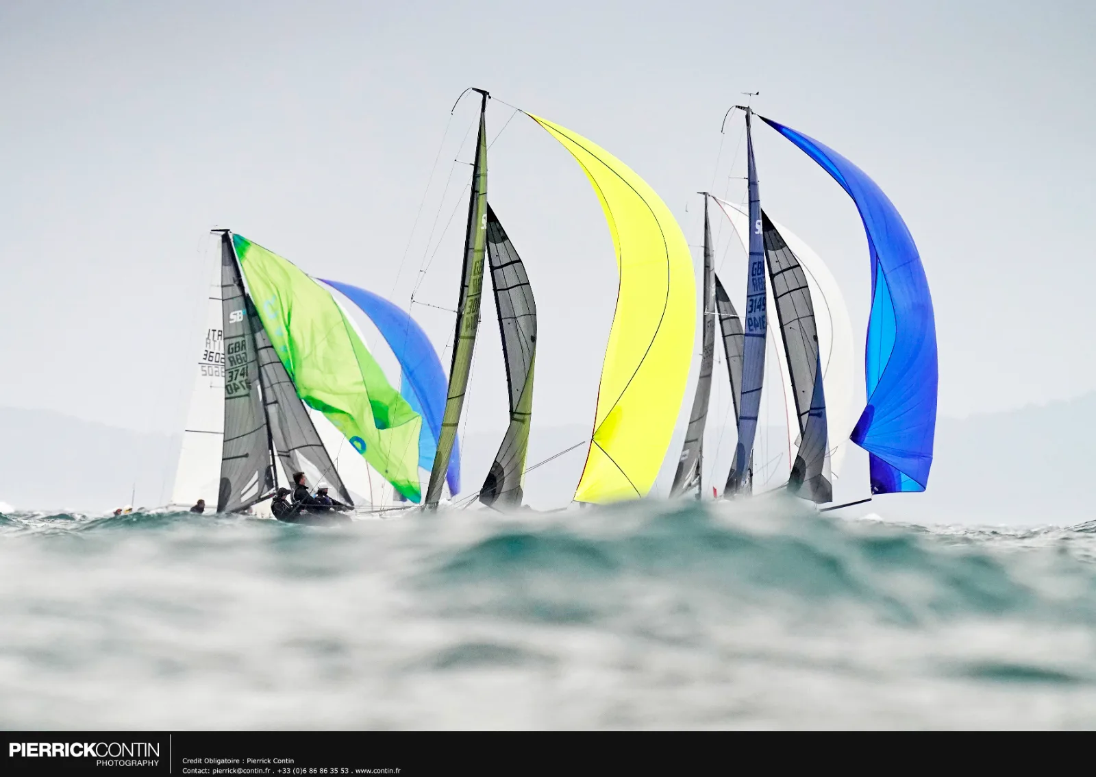 SB20s racing downwind under colourful gennakers at Hyères
