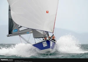 SB20 planing downwind under gennaker in a burst of spray at Hyères