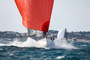 SB20 planing under a red spinnaker in the Mistral