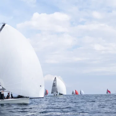 SB20 sailing downwind under a white gennaker with the fleet behind on the practice day of the SB20 World Championship in Hyères
